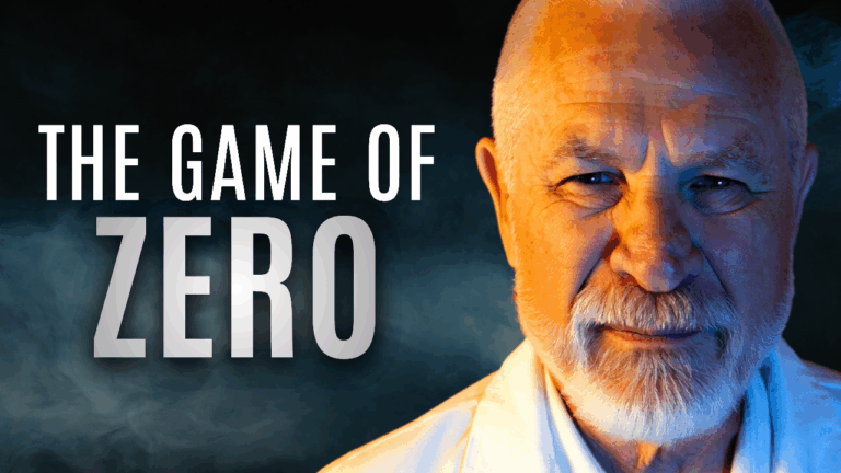 A cinematic close-up portrait of an elderly man with a bald head and trimmed white beard, softly lit with blue and golden light that creates a sense of depth and mystery. His calm, piercing gaze faces the camera with a faint smile. To the left, bold white text reads “THE GAME OF ZERO” against a dark, smoky blue background. The overall mood is contemplative, spiritual, and cinematic, evoking themes of wisdom, stillness, and inner mastery.